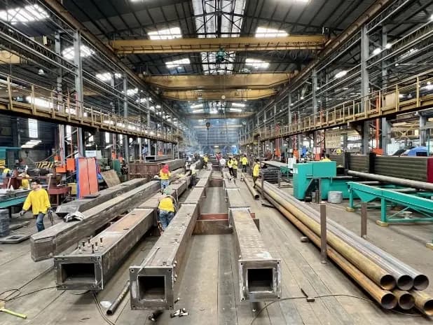 Structural steel sections in a fabrication workshop